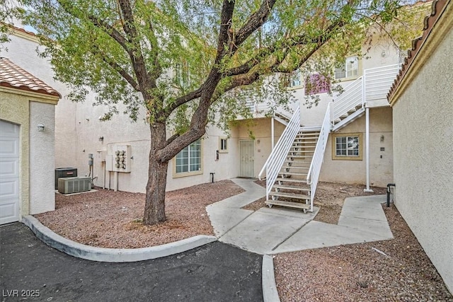 view of patio / terrace featuring cooling unit and stairs