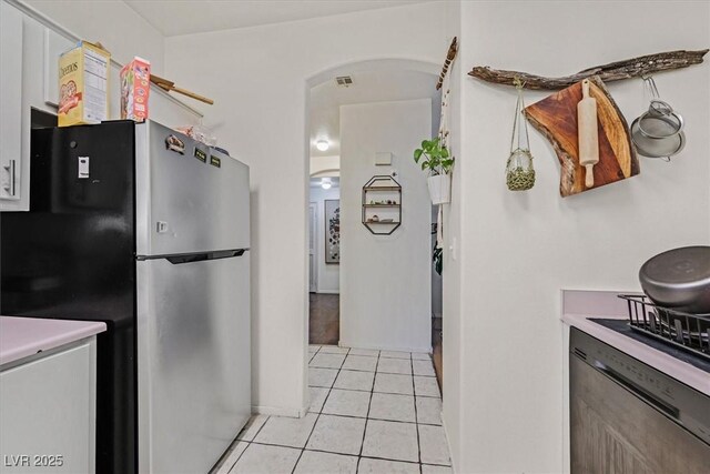 kitchen featuring stainless steel fridge and light tile patterned floors