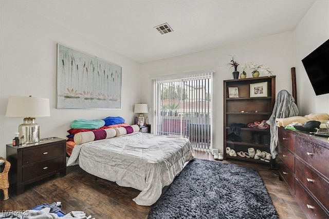 bedroom featuring dark hardwood / wood-style floors and access to outside