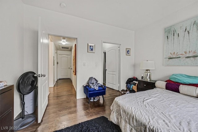 bedroom featuring dark wood-type flooring and visible vents