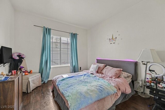 bedroom with dark wood-type flooring