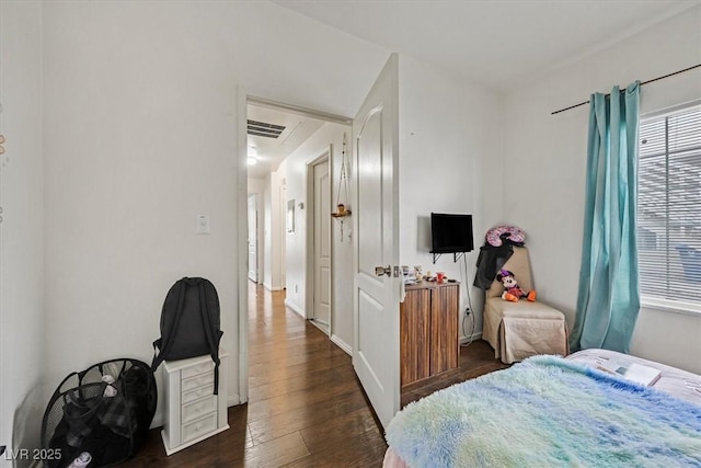 bedroom with dark hardwood / wood-style floors