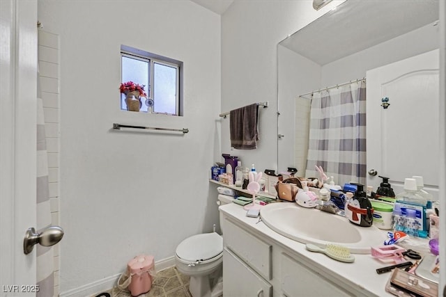 bathroom with a shower with curtain, tile patterned floors, vanity, and toilet