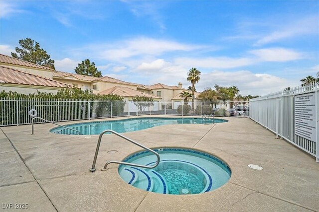 view of swimming pool with a community hot tub and a patio area