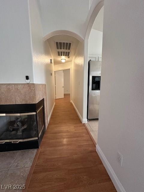 corridor with hardwood / wood-style flooring