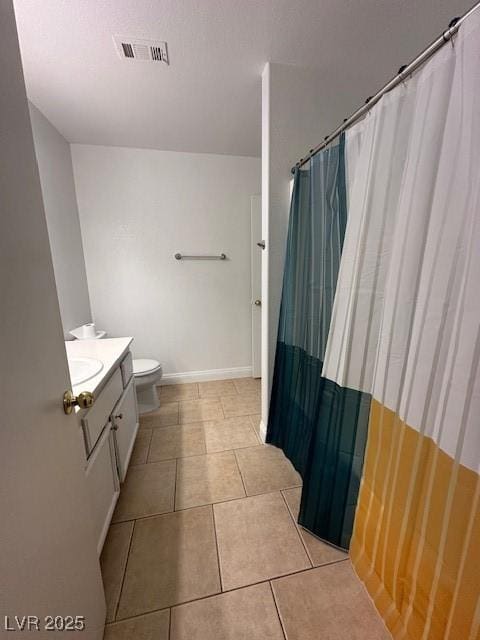 bathroom with vanity, tile patterned floors, and toilet