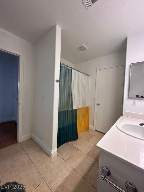 bathroom with tile patterned floors and vanity