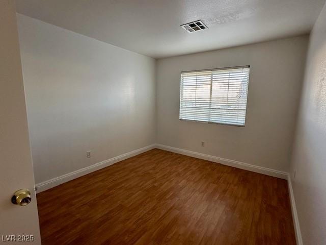 unfurnished room featuring dark hardwood / wood-style flooring