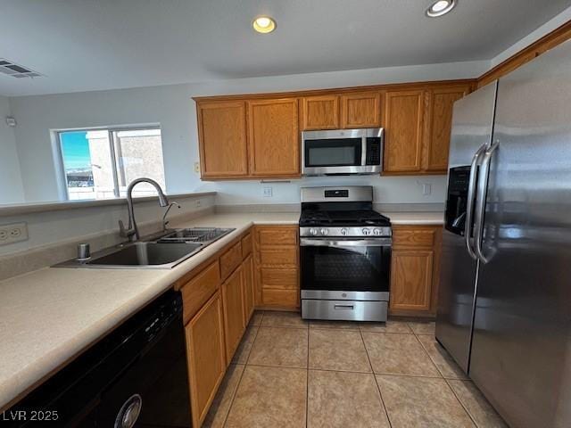 kitchen featuring light tile patterned flooring, stainless steel appliances, and sink