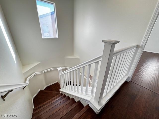 stairway featuring wood-type flooring