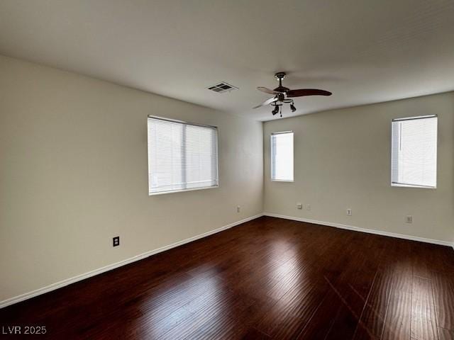 unfurnished room with dark hardwood / wood-style floors and ceiling fan