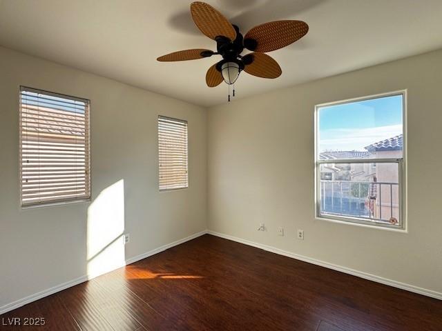 unfurnished room with dark hardwood / wood-style flooring and ceiling fan