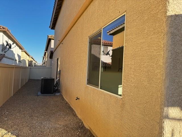 view of side of home with central AC unit