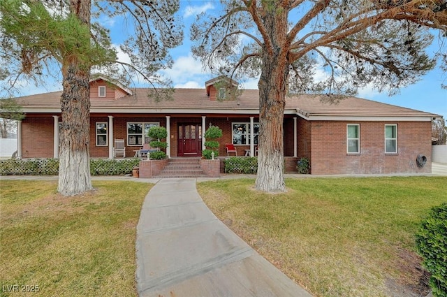 single story home with a front yard and covered porch