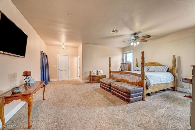 bedroom with a textured ceiling, ceiling fan, and carpet flooring