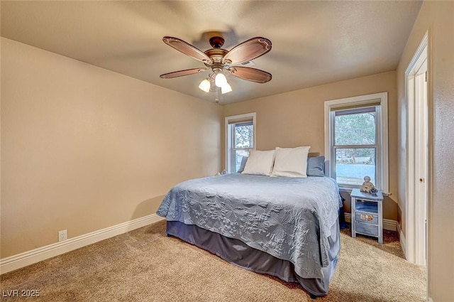 carpeted bedroom featuring multiple windows and ceiling fan