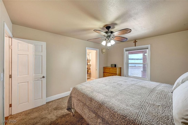 carpeted bedroom with ceiling fan and a textured ceiling