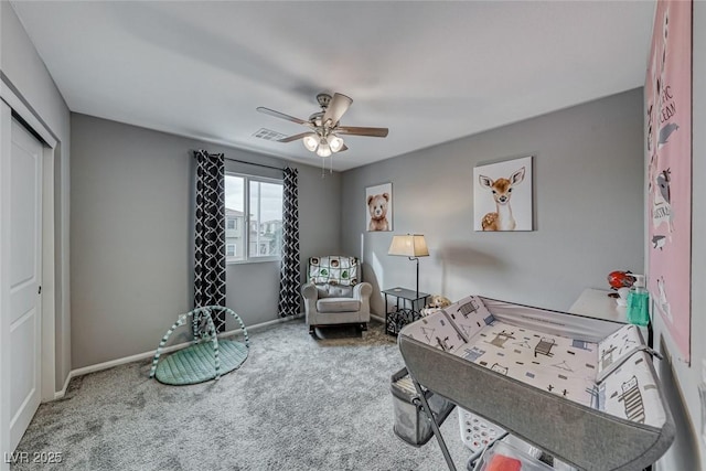 sitting room featuring ceiling fan and carpet