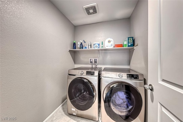 clothes washing area featuring independent washer and dryer