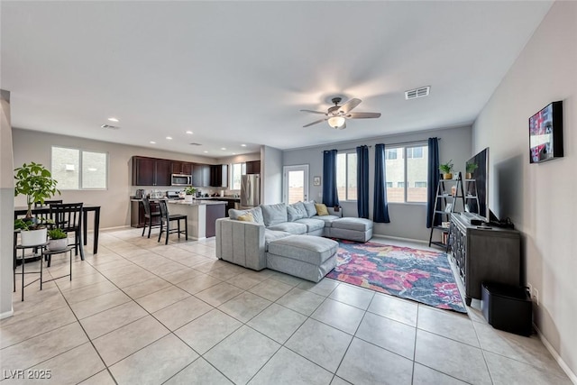 tiled living room with ceiling fan