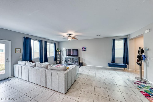 living room featuring ceiling fan and light tile patterned floors