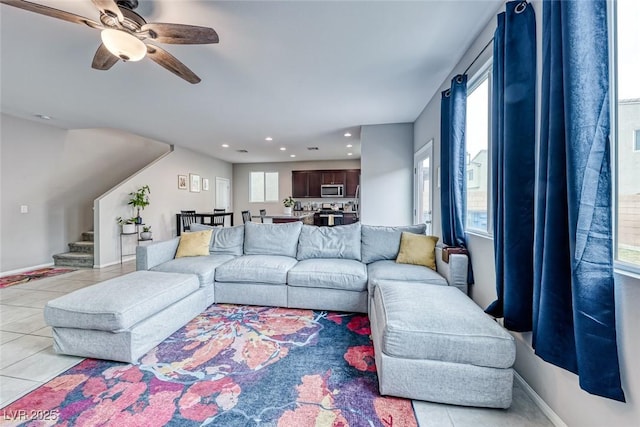 tiled living room with ceiling fan