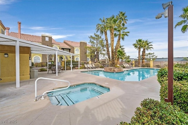 view of swimming pool featuring a patio area and a community hot tub