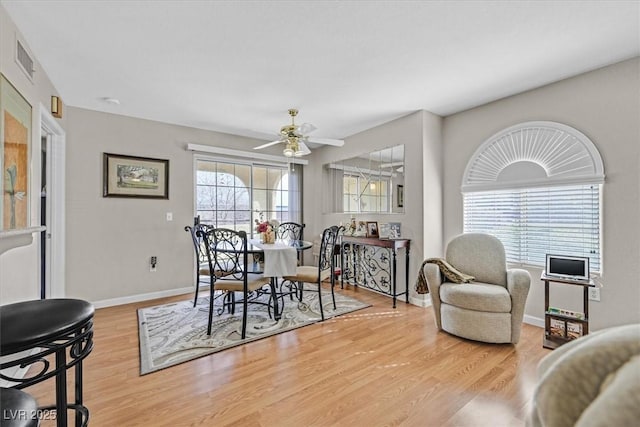 dining area with ceiling fan, plenty of natural light, and light hardwood / wood-style floors