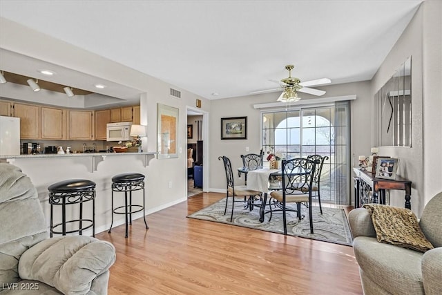 dining area featuring ceiling fan and light wood-type flooring