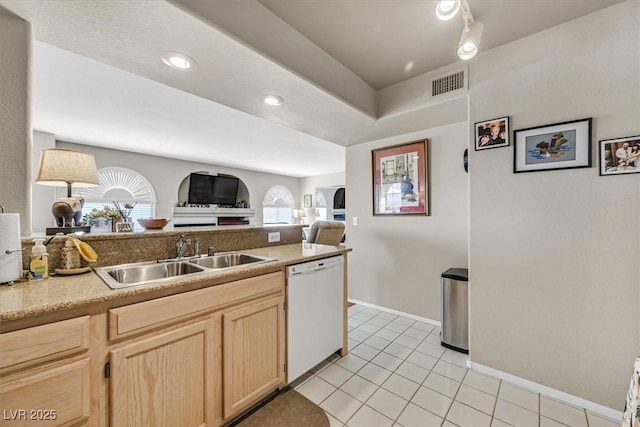 kitchen featuring a healthy amount of sunlight, sink, dishwasher, and light brown cabinets