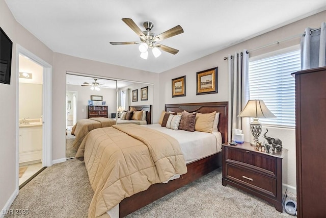 bedroom with light carpet, connected bathroom, and ceiling fan