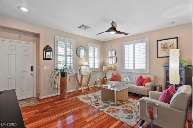 living room with ceiling fan and light hardwood / wood-style flooring