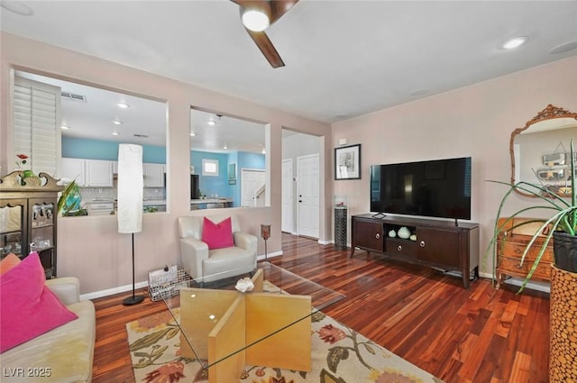 living room featuring dark hardwood / wood-style floors and ceiling fan