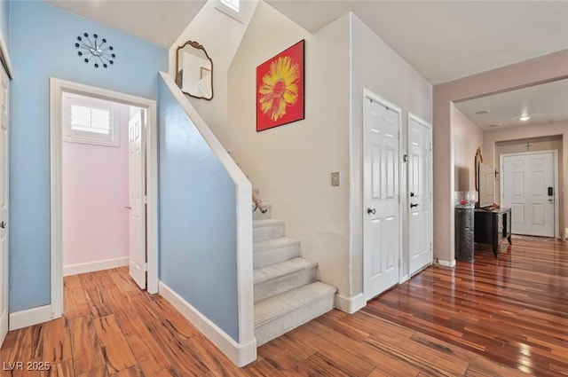 stairway with hardwood / wood-style flooring