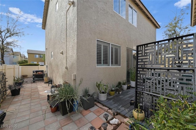 view of side of home with a patio