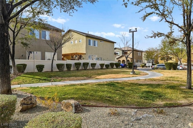 view of home's community with a yard