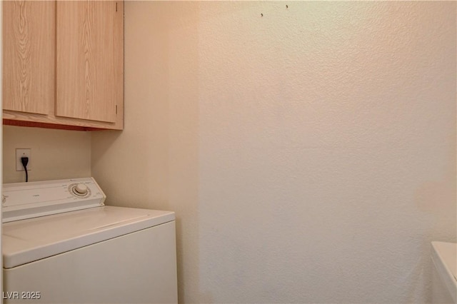 laundry room featuring washer / clothes dryer and cabinet space