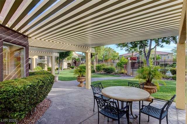 view of patio featuring fence, a pergola, and outdoor dining space