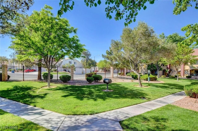 view of property's community with a yard and fence