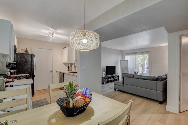 dining space with light wood finished floors