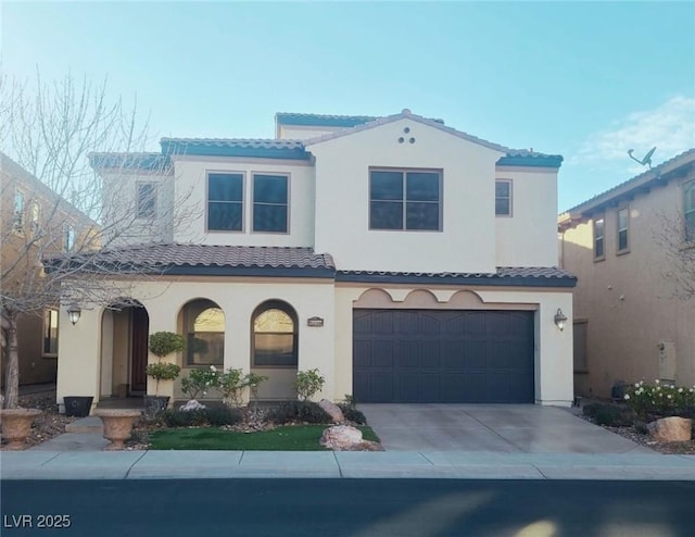 view of front of property featuring a garage, concrete driveway, a tile roof, and stucco siding