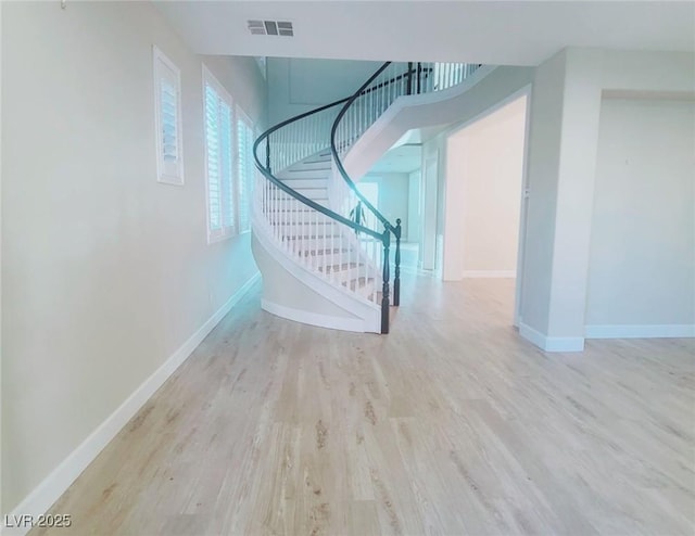 stairs featuring hardwood / wood-style flooring