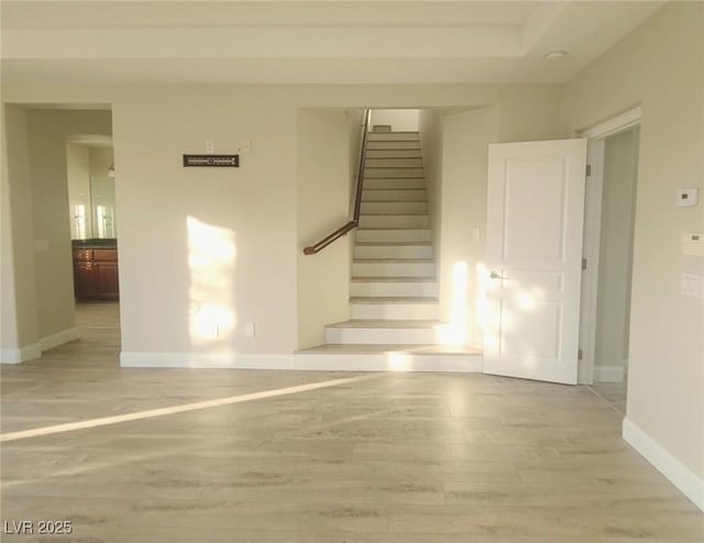 staircase with hardwood / wood-style floors