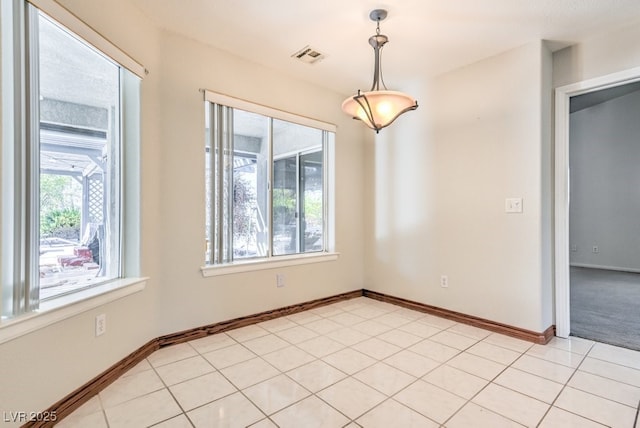 spare room featuring light tile patterned floors