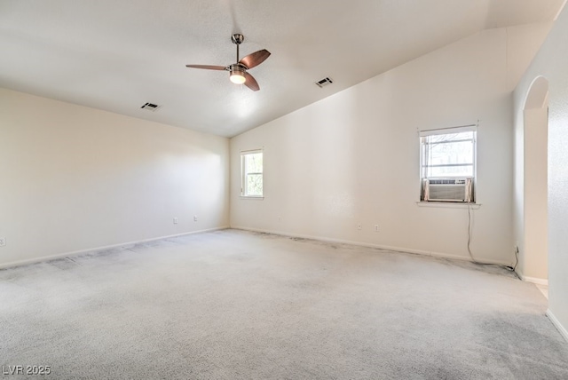 carpeted empty room with high vaulted ceiling, cooling unit, and ceiling fan