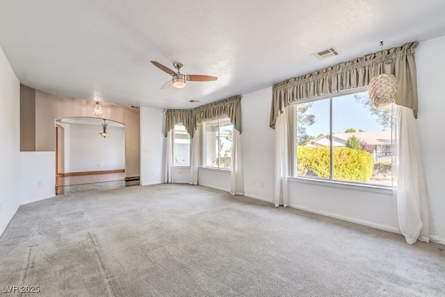 empty room featuring carpet flooring, a textured ceiling, and ceiling fan