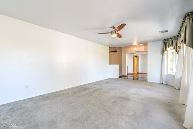 carpeted spare room featuring ceiling fan