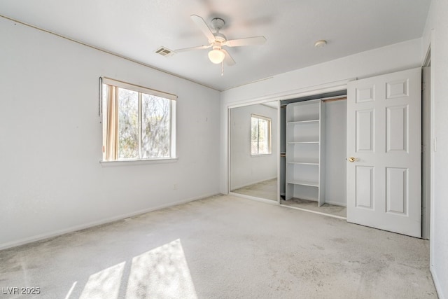 unfurnished bedroom with light carpet, ceiling fan, and a closet