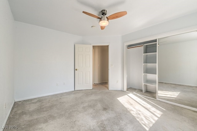 unfurnished bedroom featuring light carpet, a closet, and ceiling fan