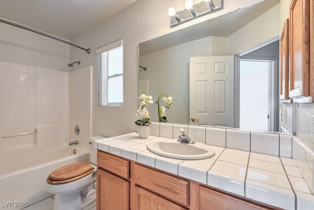 full bathroom with vanity, shower / bathtub combination, and toilet